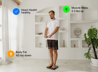 Man using a fitness tracker in a bright room with white walls and a plant.
